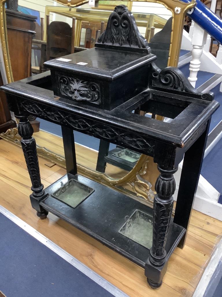 A late Victorian ebonised oak hallstand carved in Flemish style, length 77cm, depth 32cm, height 100cm